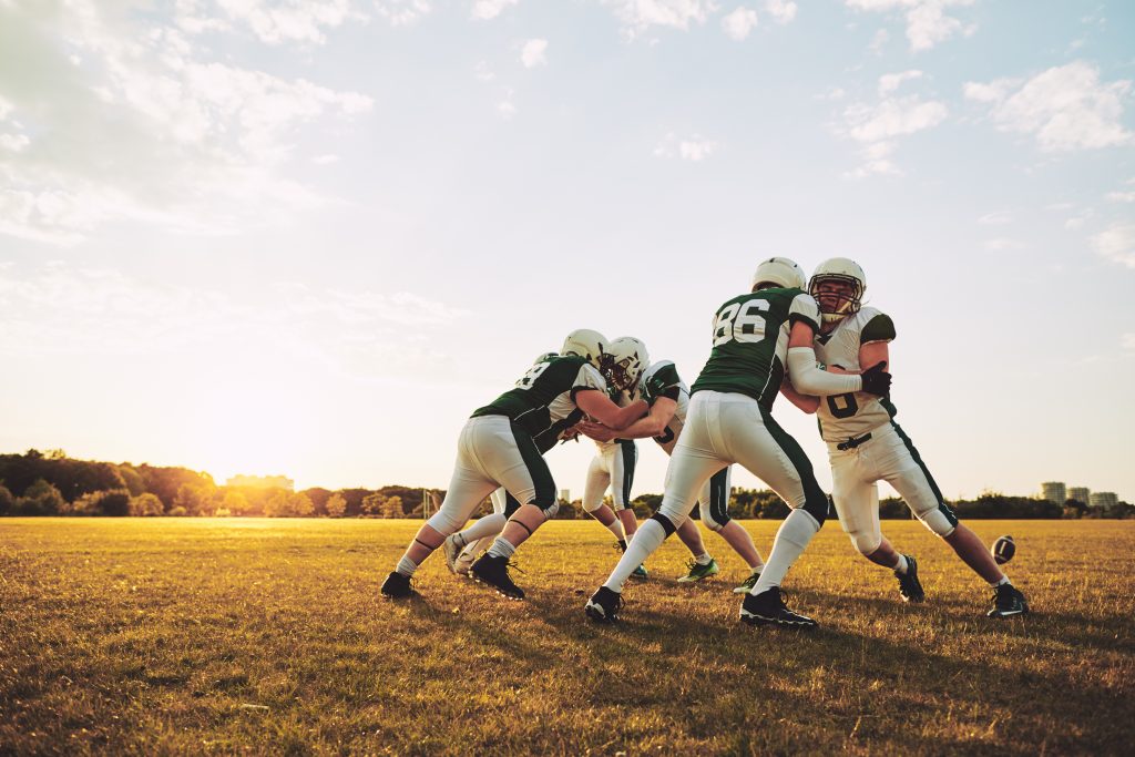 american football team doing defensive drills NEP7TAV